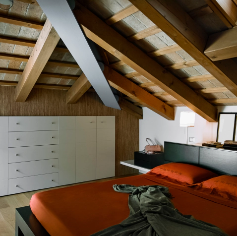 attic bedroom with wooden ceiling